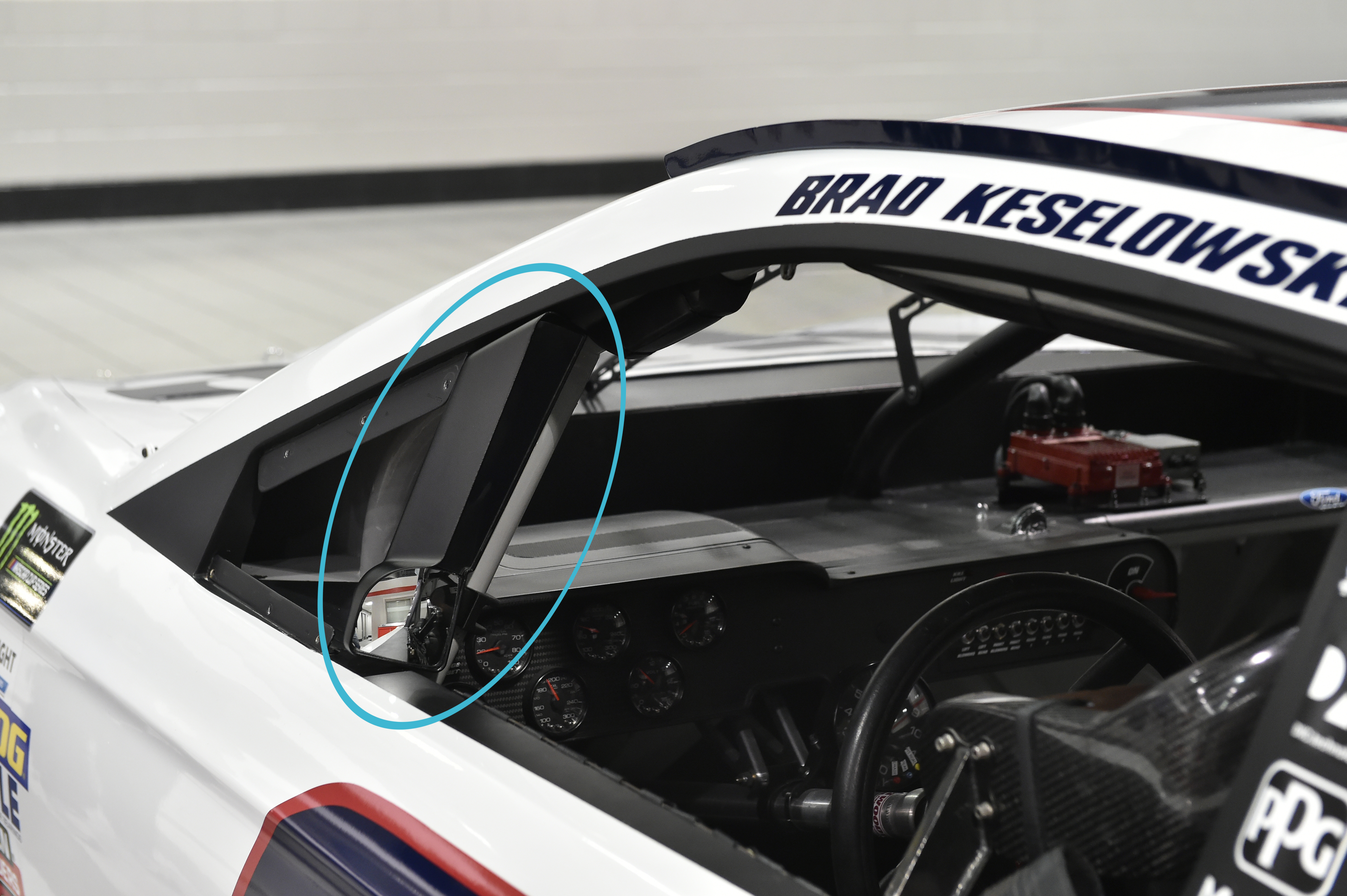 Customized carbon-fiber-filled Nylon 12 mirror housing installed on #22 Discount Tire car. The composite's stiffness prevents the mirror housings from flexing under the aerodynamic loads produced on track.