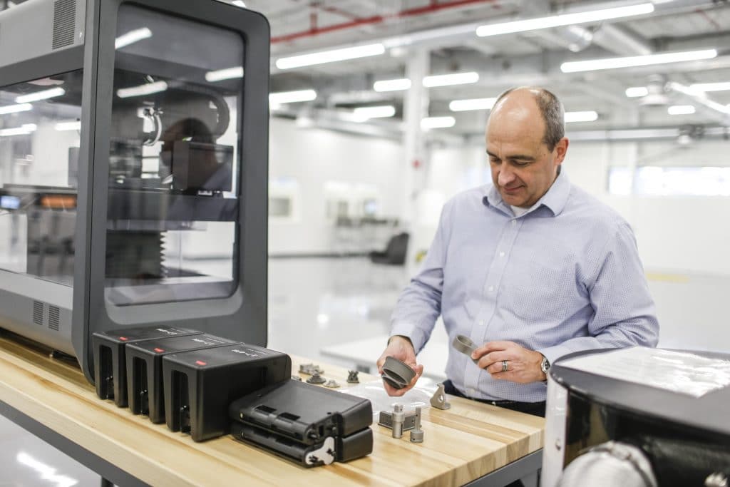 Harold Sears, additive manufacturing technical leader at Ford’s Advanced Manufacturing Center, studies 3D printed parts printed with Desktop Metal's Studio System+.