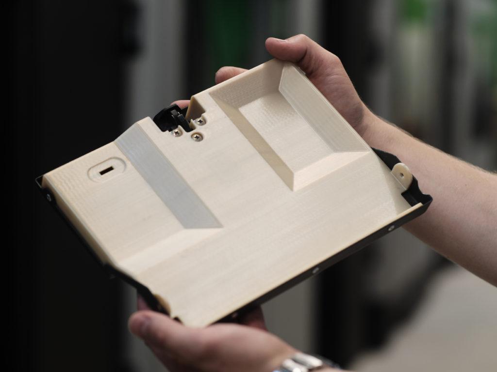 Life vest compartment door that was 3D printed using ULTEM 9085.